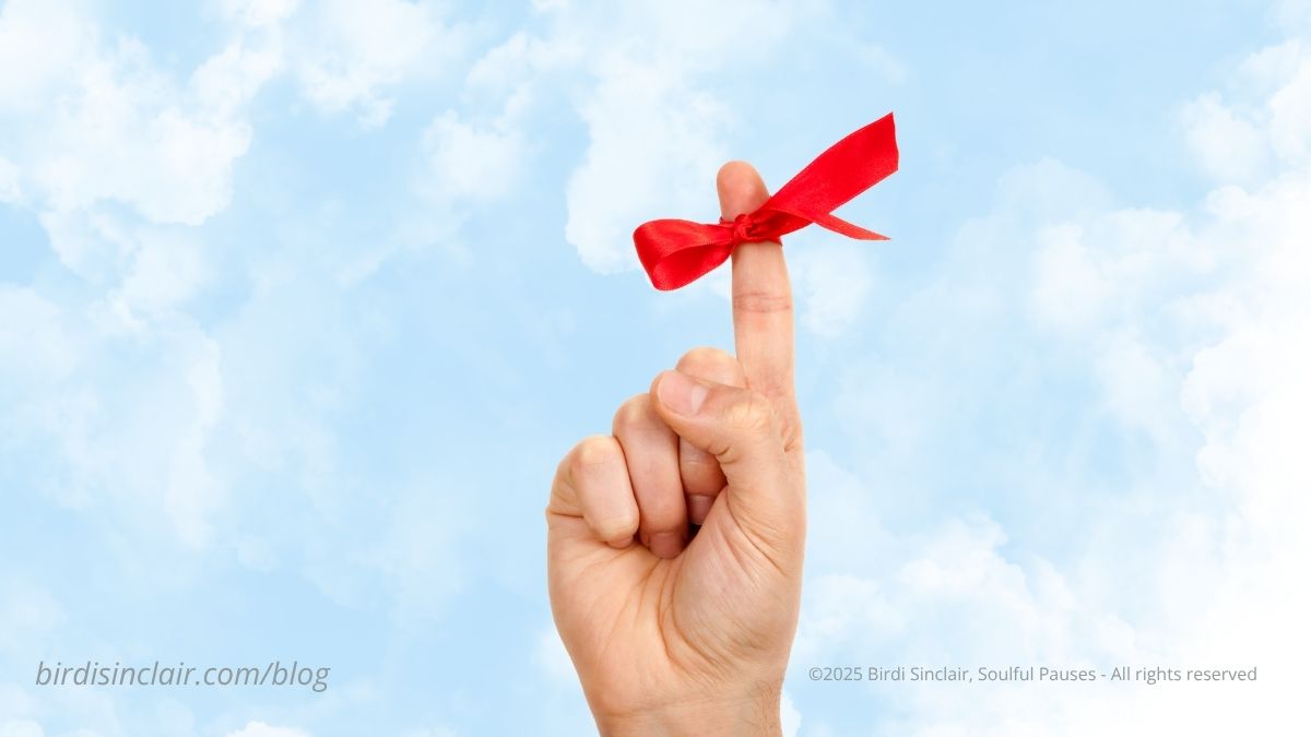 red ribbon tied to finger